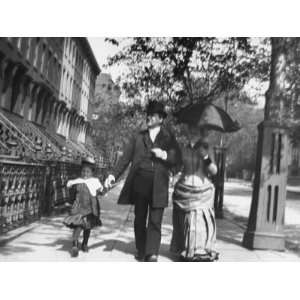 Incredibly Well Dressed Man, Woman and Child Walking by Perfect 