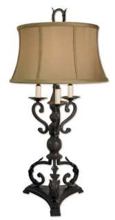 This table lamp is finished in a mahogany bronze with plated Bobeches 