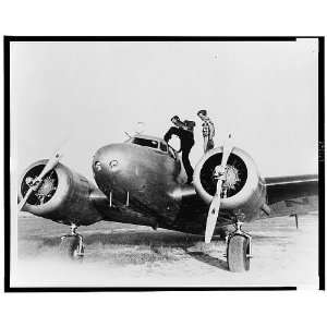 Fred Noonan standing on wing of airplane,cockpit,Amelia Earhart,Puerto 