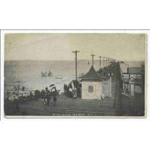   . people on boardwalk, entrance building to pier, old utility poles