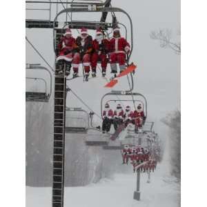 Skiers and Snowboarders Dressed as Santa Claus Ride up the Ski Lift 