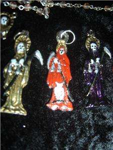 This Santisima Muerte pendant is hand painted in specialty enamels 