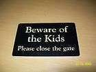 beware of the kids please close the gate sign location