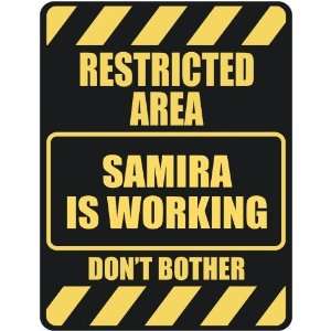   RESTRICTED AREA SAMIRA IS WORKING  PARKING SIGN