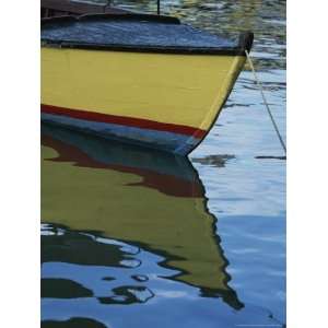  The Bow of an Anchored, Striped Boat is Reflected on the 