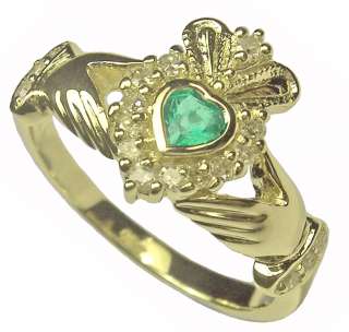   and is hallmarked set at the center is a faceted heart cut emerald