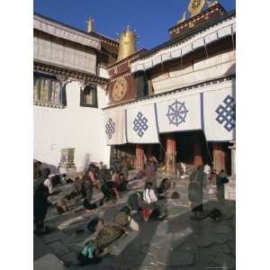 Tibetan Buddhist Pilgrims Prostrating in Front of the Jokhang Temple 